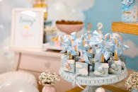 Elegant baby shower dessert table with pastel decorations and sweet treats.